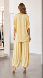 Back view of model wearing yellow matching top and pants set