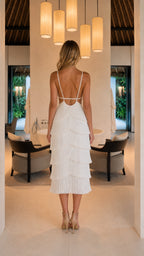 Back view showing open back and straps of white fringe dress