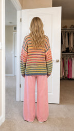 Back view of model showing relaxed fit and striped pattern
