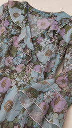 Close-up detail of ruffle neckline and floral fabric