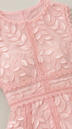 Close-up detail of bodice, neckline, and leaf embroidery on pink dress
