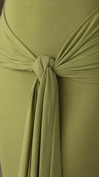 Close-up detail of the front waist knot and drape on the olive dress