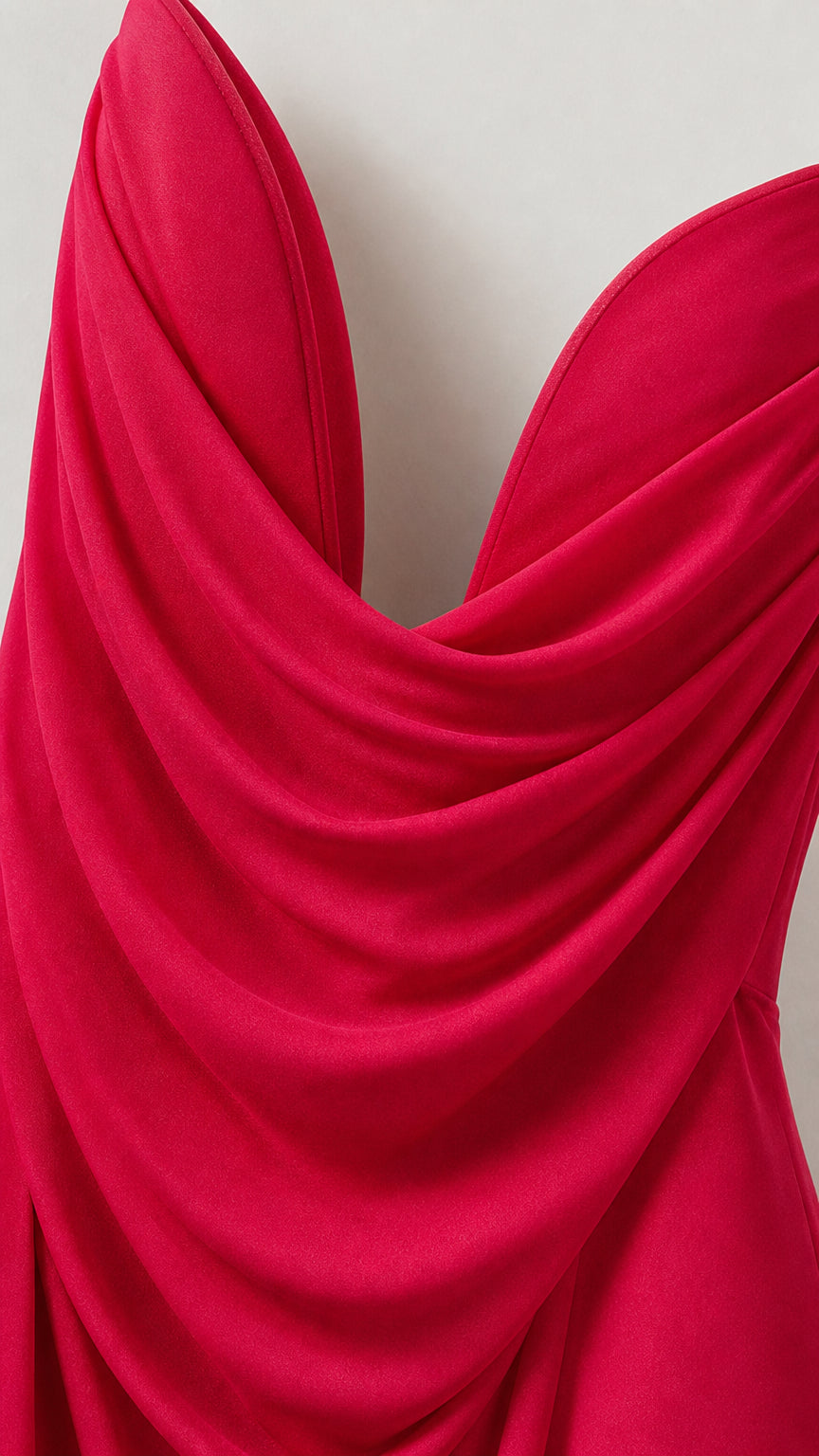 Close-up detail of fuchsia fluid draped fabric and cowl neckline