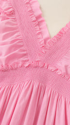 Close-up detail of smocked bodice and ruffled straps in pink