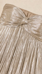 Close-up of knotted sweetheart bodice detail on gold metallic dress