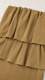 Close-up detail of the layered ruffles on the olive top