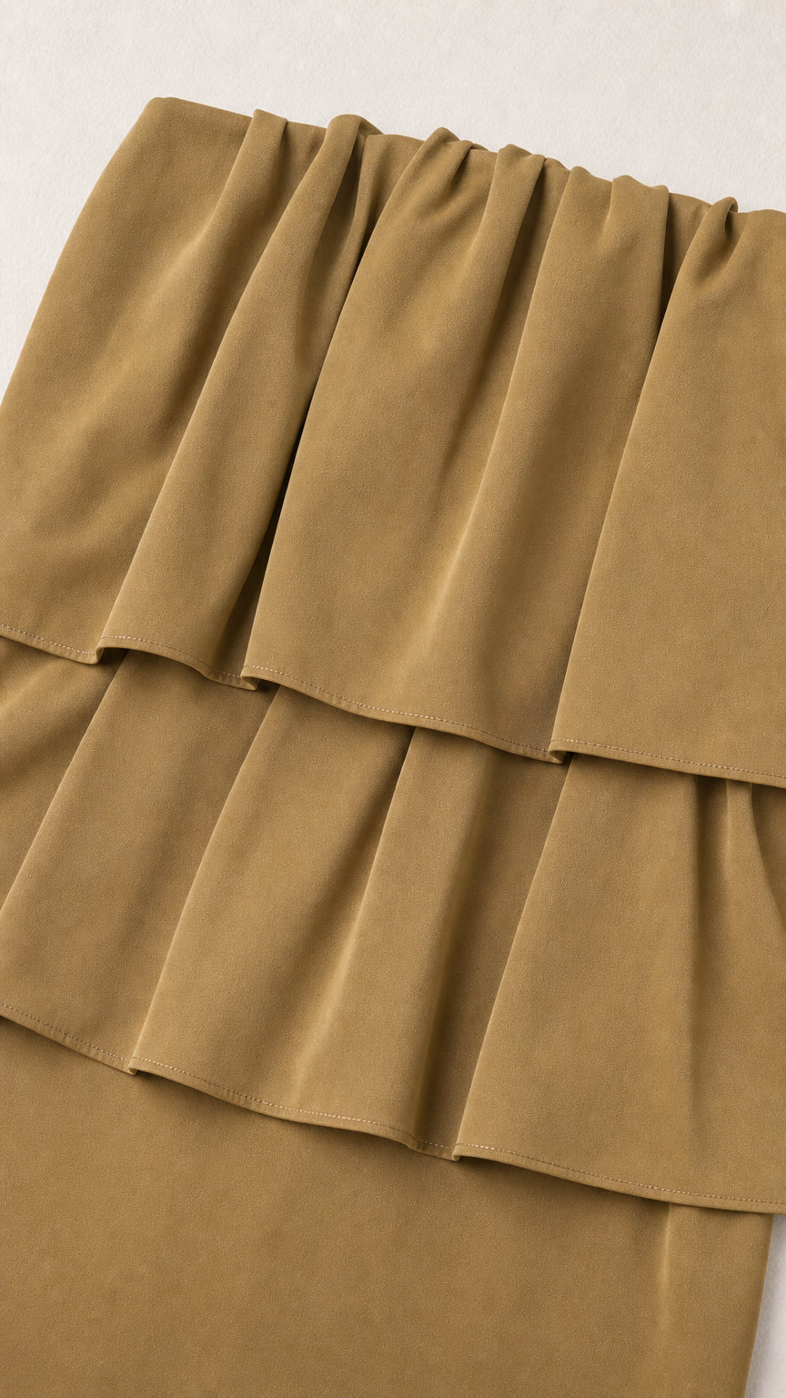 Close-up detail of the layered ruffles on the olive top