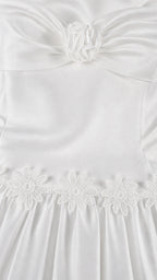 Close-up of floral bodice detail and embroidered skirt seam on white set
