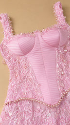Close-up detail of structured pink corset bodice and beaded waist