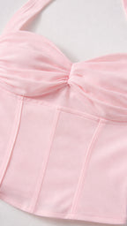 Close up of pink corset top bodice and twist detail