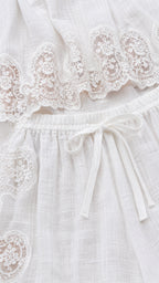 Close-up of white crochet lace trim and drawstring waistband
