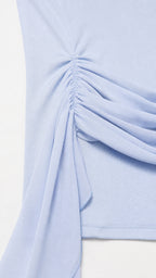 Close-up detail of hip ruching and fabric sash