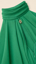 Close up of neckline detail with gold heart charm on green dress