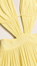 Close-up detail of front bodice and waist cutout on yellow dress