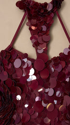 Close-up detail of textured circular sequins and halter neckline