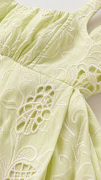 Close-up detail of tonal floral embroidery and eyelet cutwork on Light Green fabric