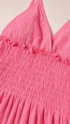 Close-up of pink dress textured fabric and smocked bodice detail