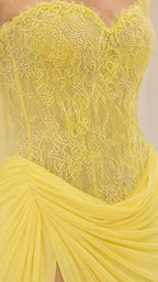 Close-up of the lemon yellow lace-textured bodice and ruched skirt detail