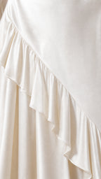 Close-up detail of the satin fabric and ruffle hem