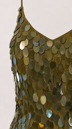 Close-up detail of large disc sequins on olive green dress