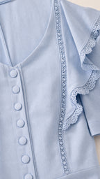 Close-up detail of V-neck, buttons, and lace trim on Light Blue dress