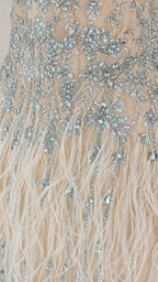 Close up of crystal beadwork and feather detail on dress