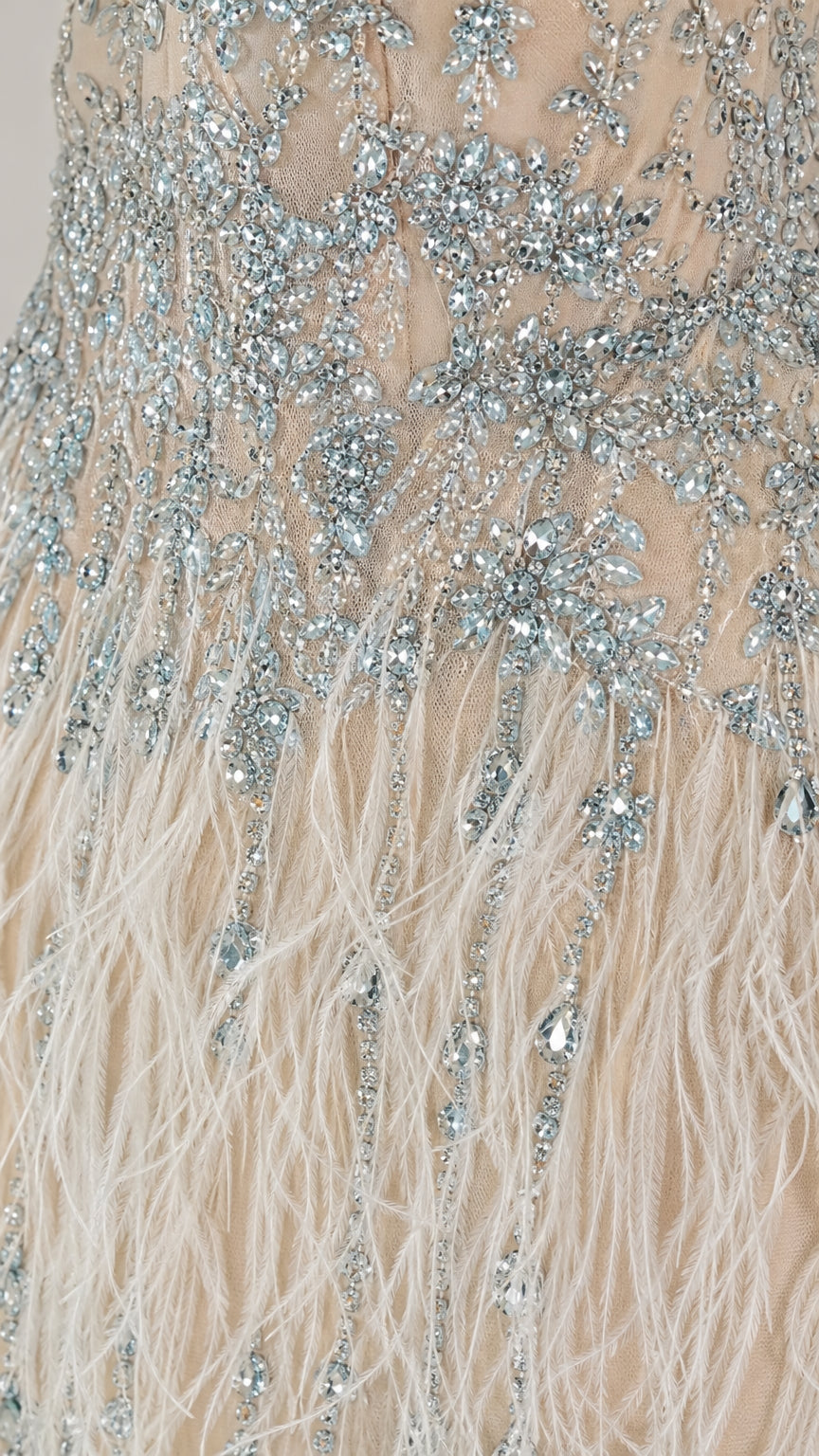 Close up of crystal beadwork and feather detail on dress