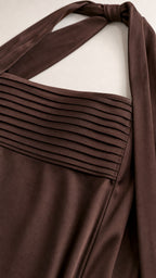Close-up of pleated bodice and necktie detail in brown