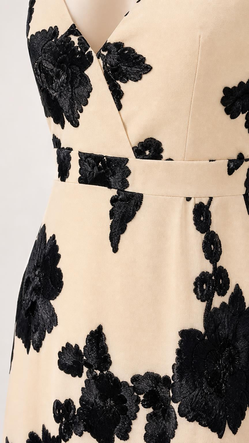 Close up of V-neckline and floral applique details