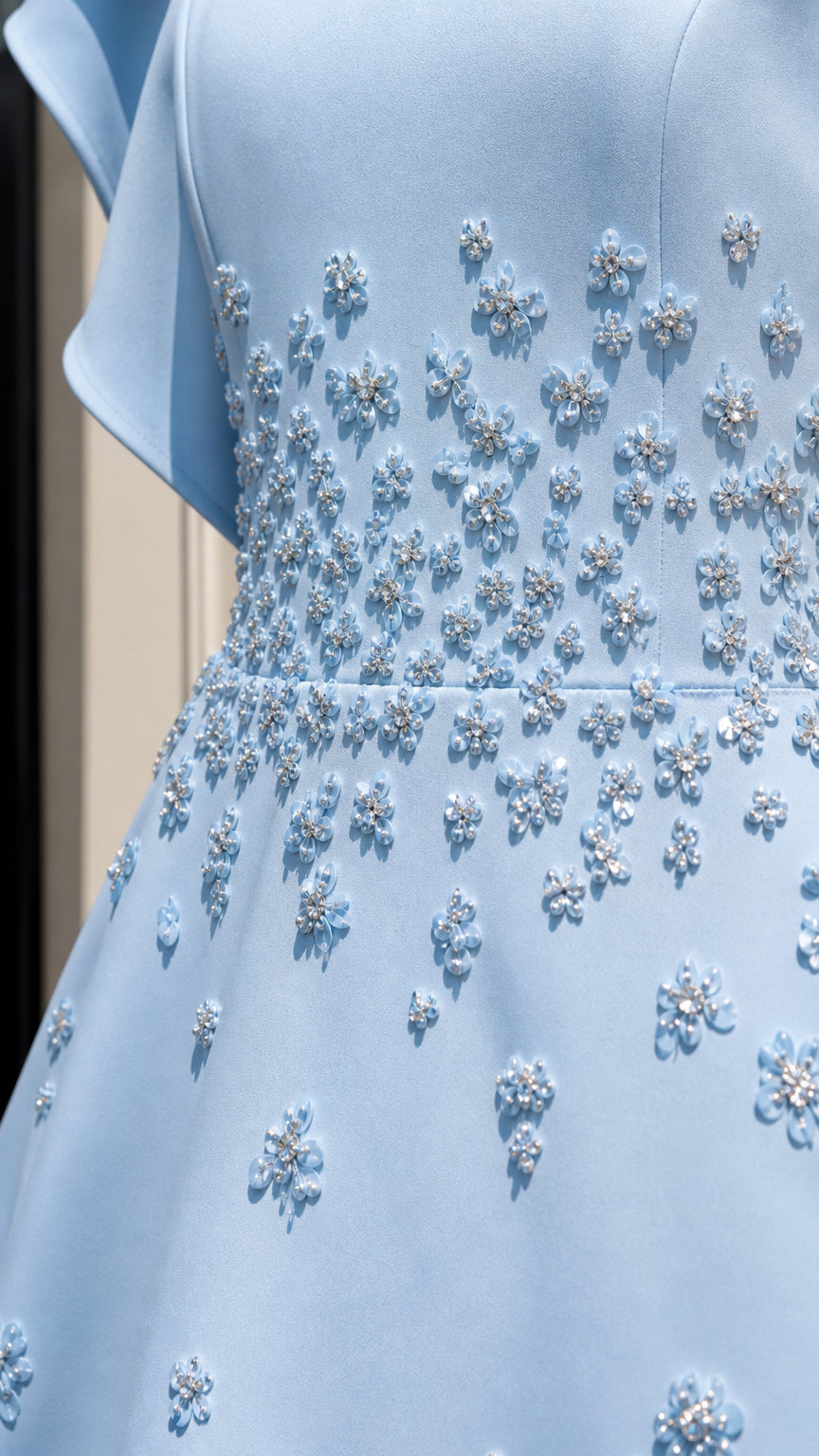 Close-up detail of floral beadwork on bodice