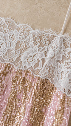 Close-up detail of white lace trim and shimmering sequins