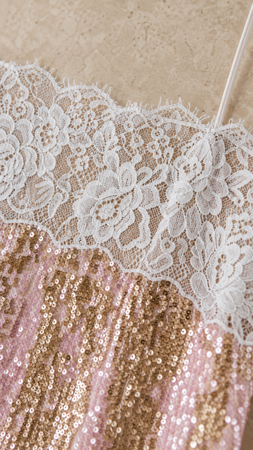 Close-up detail of white lace trim and shimmering sequins