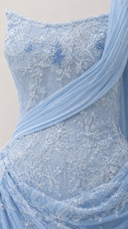 Close-up detail of lace embroidery and draped chiffon fabric