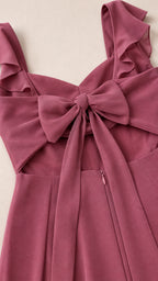Close-up detail of ruffle straps and back bow