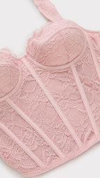 Close-up detail of pink lace corset top construction