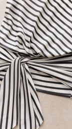 Close-up detail of fabric pattern and side knot tie