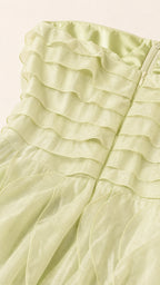 Close-up of sage green fabric texture and ruffles