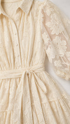 Close-up detail of shirt collar, buttons, and sheer floral embroidery