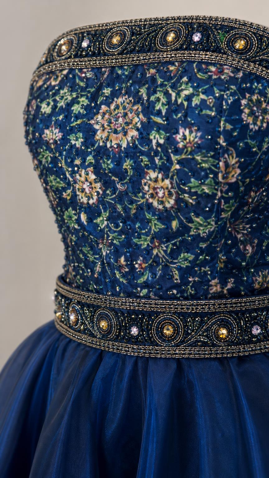 Close-up detail of beaded embroidery on the bodice and waist