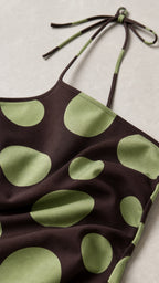 Close-up detail of halter neckline and polka dot fabric
