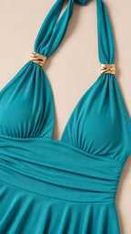 Close-up detail of metallic ring hardware and ruched bodice