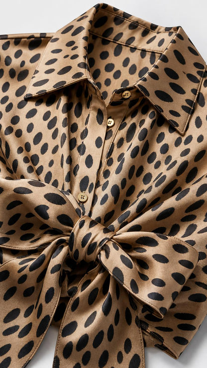Close-up detail of shirt collar and front tie knot in camel print