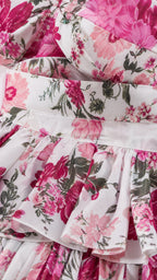Close-up detail of the floral print fabric and ruffle tiers
