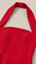 Close-up detail of red halter neck strap and bodice