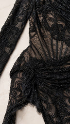 Close-up detail of lace pattern and texture on black gown