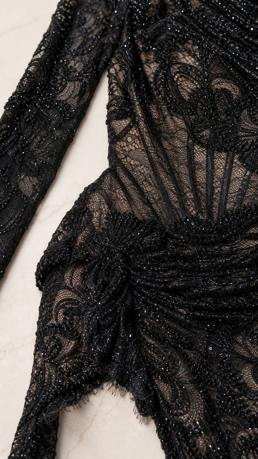 Close-up detail of lace pattern and texture on black gown