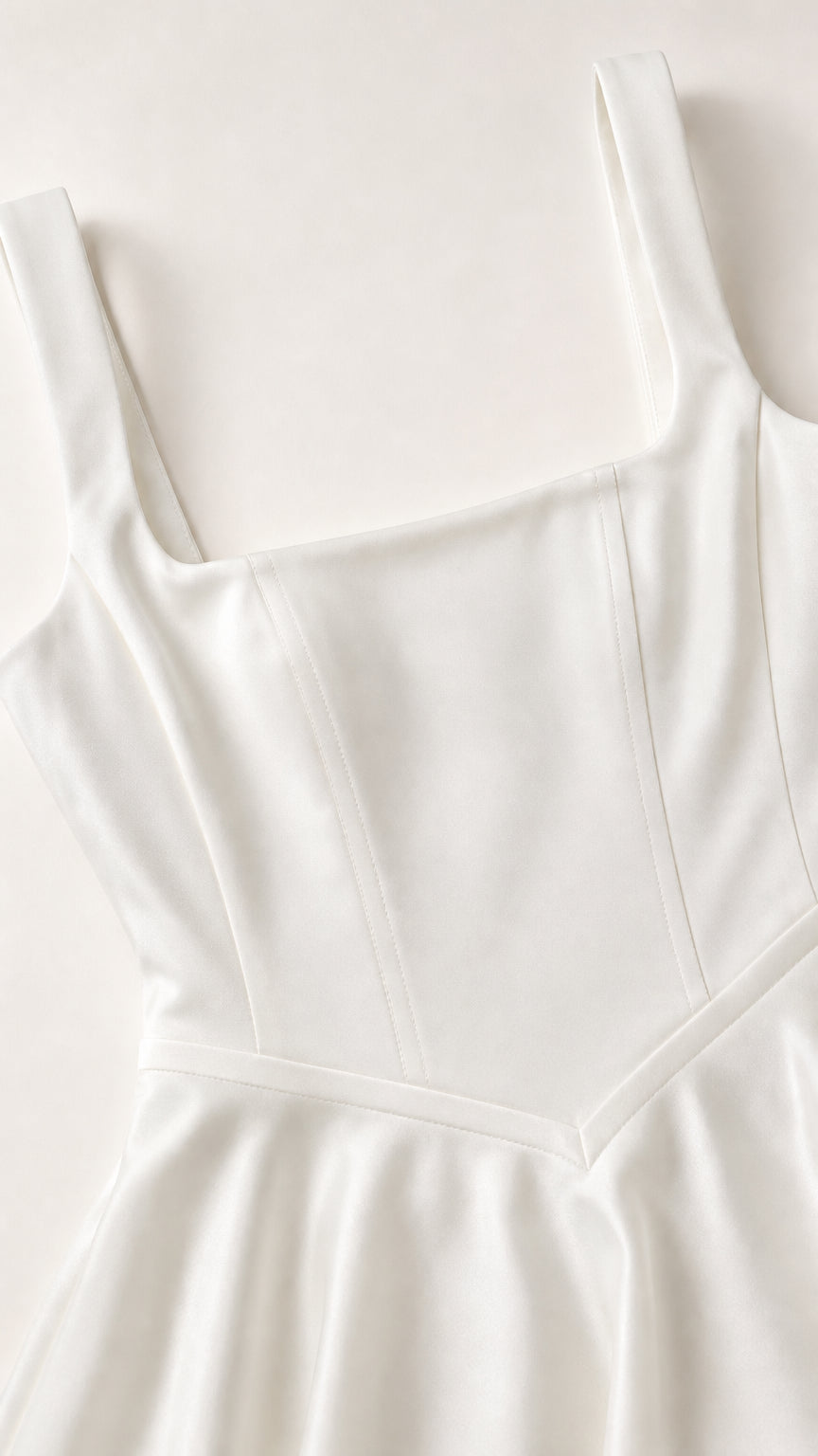 Close-up detail of white dress bodice and square neckline