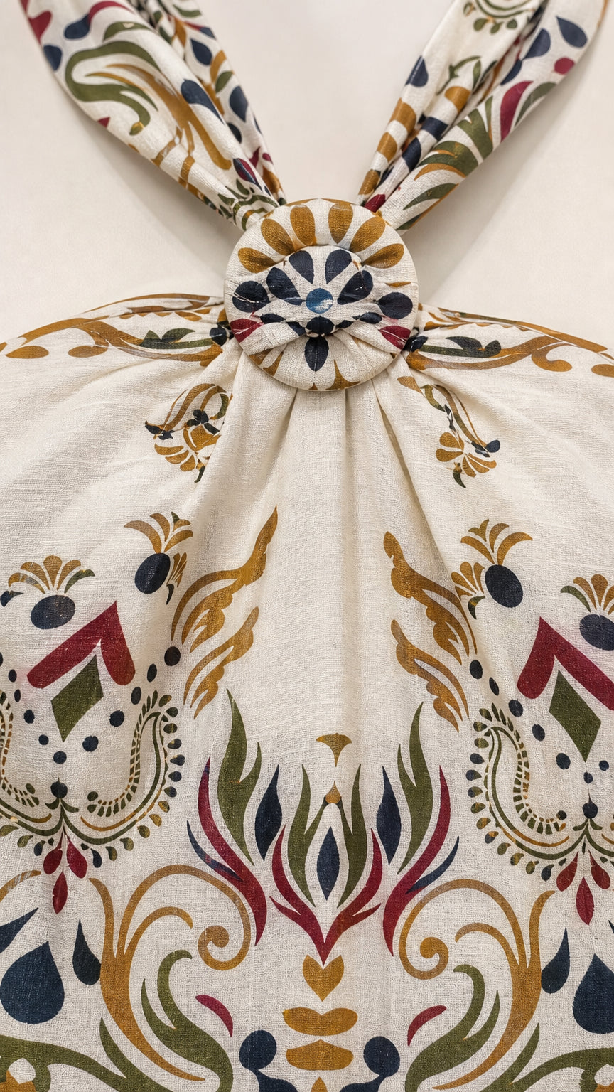 Close-up of the front knot detail on the cream halter top