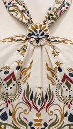 Close-up of the front knot detail on the cream halter top