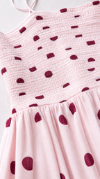 Close-up detail of smocked bodice and polka dot pattern